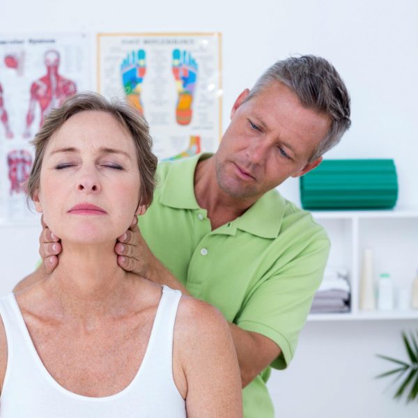 Doctor doing neck adjustment